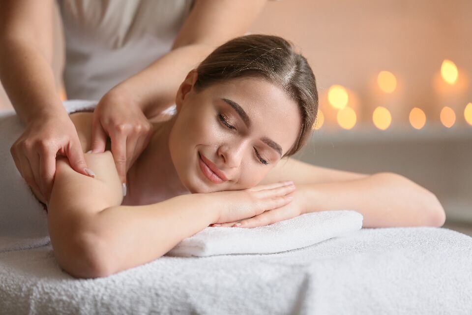 Therapist working on a guest's back and shoulders during body work at Jiameng Spa Huntington NY
