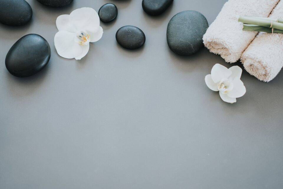 White orchids, black hot stones and soft towels at a Huntington day spa